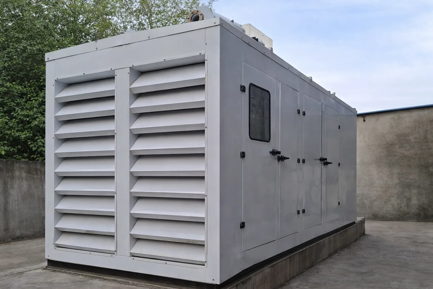 Acoustic enclosure around industrial equipment with ventilation attenuators
