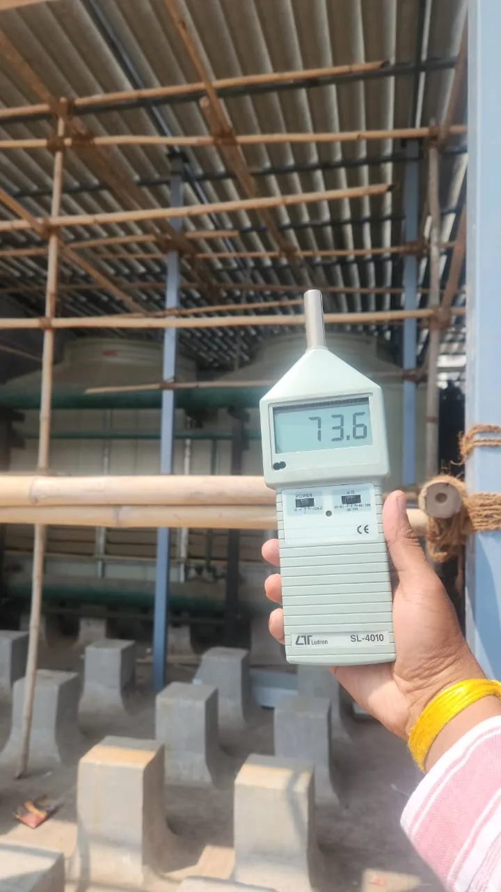 Sound-level meter displaying 73.6 beside cooling equipment